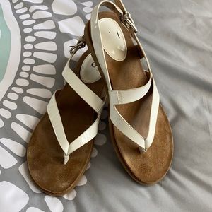 Sofit size 6.5 white patent leather thong sandals.